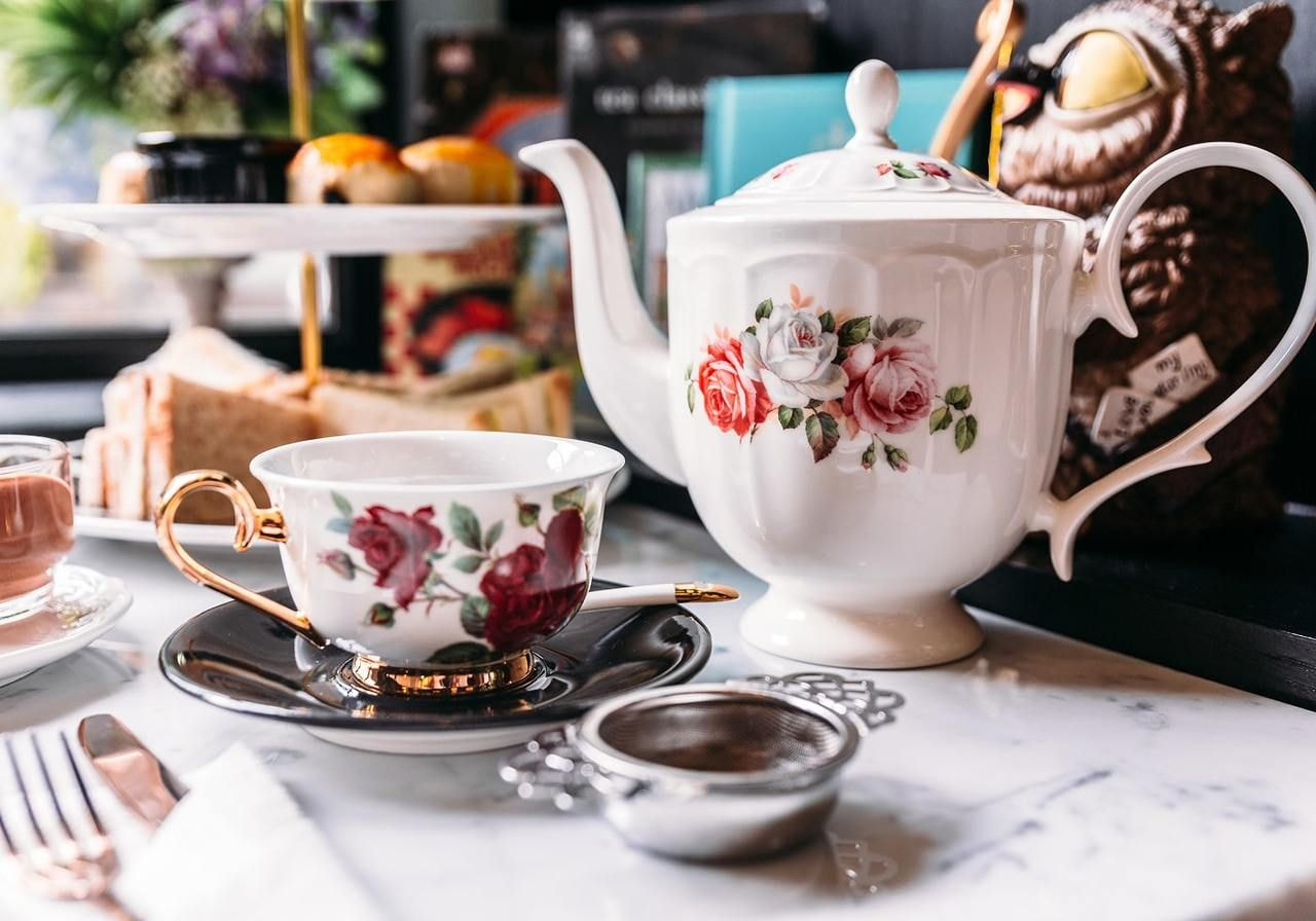 A table set with a teapot, a cup, and a saucer, arranged for a tea service.